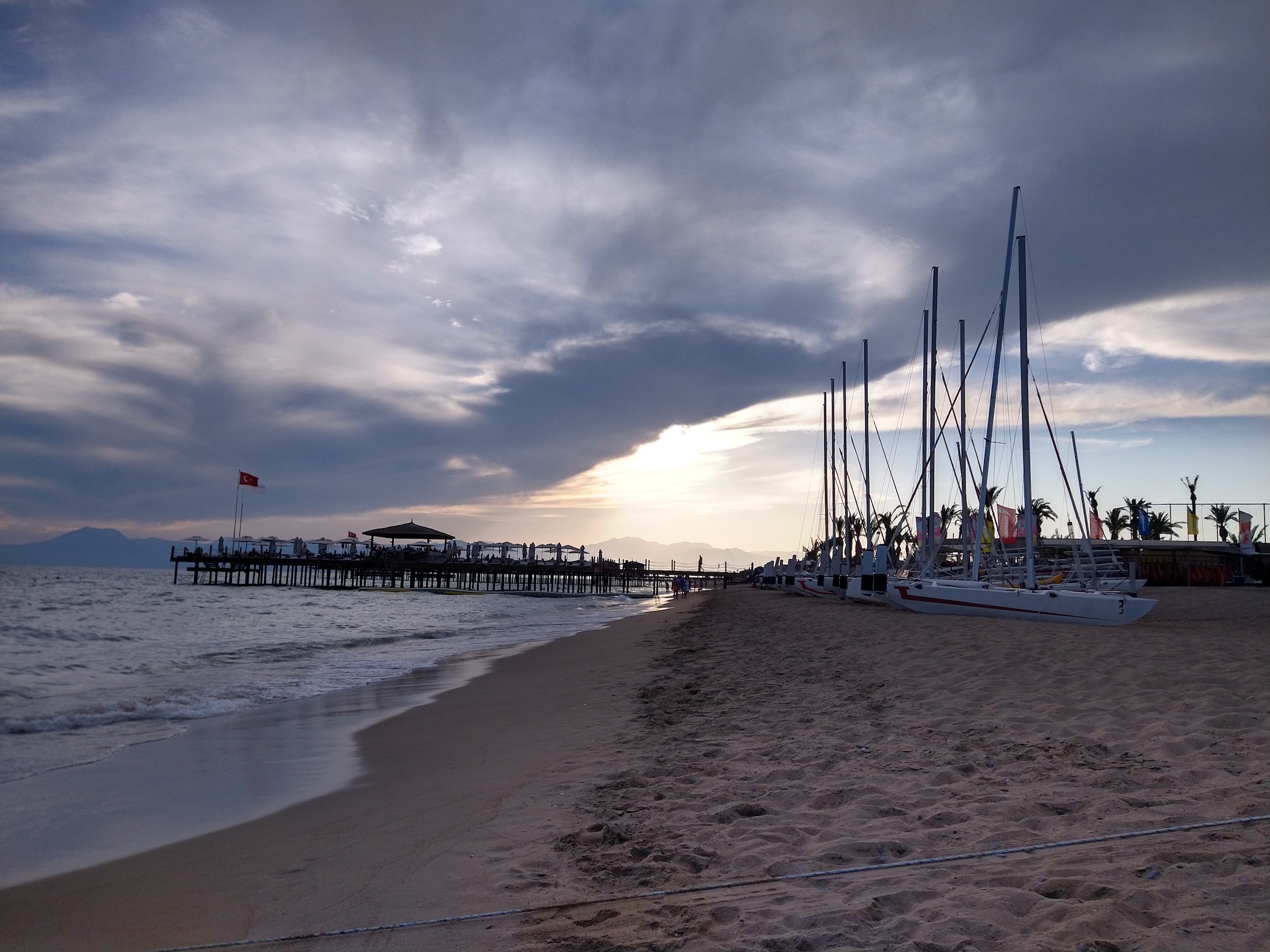 Boats sitting on a beach at sunset Boats sitting on a beach at sunset
